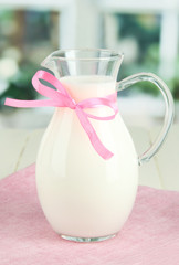 Pitcher of milk on table in room