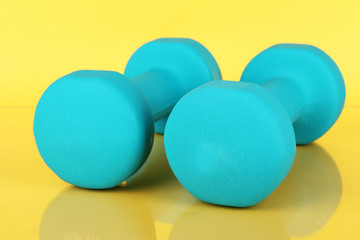 Dumbbells on yellow background