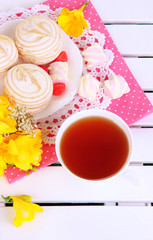 Beautiful composition with cup of tea and marshmallow