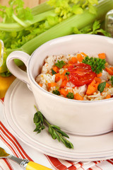 Delicious rice with vegetables and herbs in pot