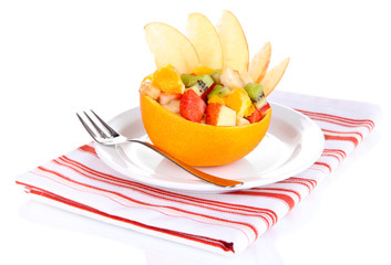 Fruit salad in hollowed-out orange isolated on white