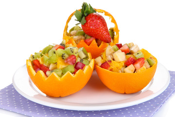 Fruit salad in hollowed-out orange isolated on white