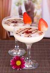 Fruit smoothies on table on window background