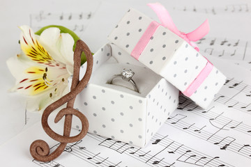 Treble clef, flower and box holding wedding ring