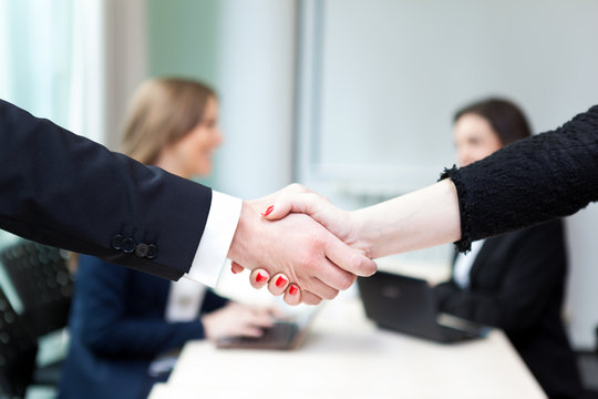 Business handshake and business people at the office