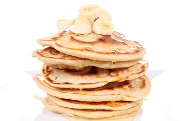 Pancakes with bananas and syrup
