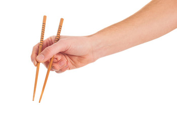 Close-up Of Hand Holding Chopsticks