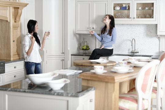 Two Friends Relaxing In The Kitchen