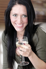 Woman relaxing on her sofa with a drink