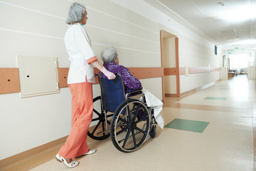 Nurse with elderly patient in wheelchair