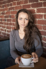 Young Woman with Beautiful Green Eyes with White Coffee Cup