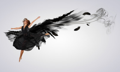 Woman floating   on dark wings