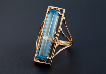 Obraz premium Golden jewelry ring with blue topaz