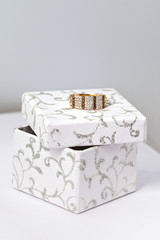 Golden jewelry on white box