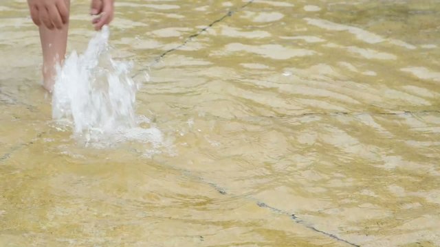Child playing with water.