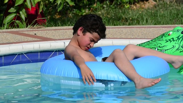 Child relaxing in swimming pool.