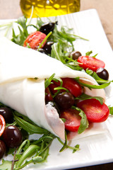 mozzarella roll with fresh tomatoes, olives and salad