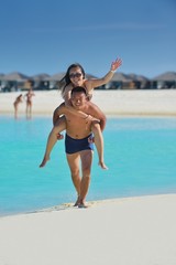 happy young  couple enjoying summer on beach