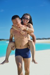 Fototapeta premium happy young couple enjoying summer on beach