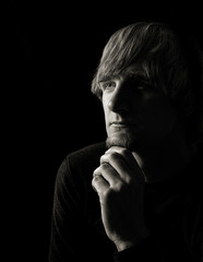 profile of young man deep in thought in toned monochrome