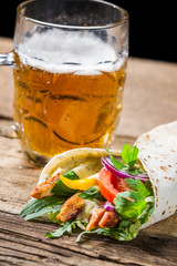 Tasty kebabs and cold beer on old wooden table