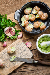 Preparing baked snails with garlic and parsley