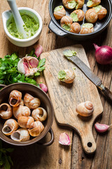 Preparing baked snails with garlic butter