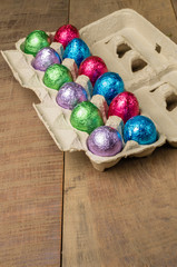 Colorful foiled eggs in container