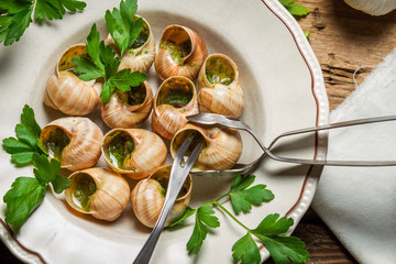 Eating the fried snails in garlic butter