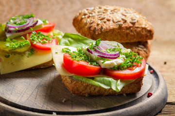 Closeup of sandwich with tomato, onion and lettuce