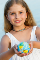 Globe on child hands, travel concept