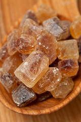 brown caramelized sugar on wooden background