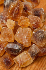 brown caramelized sugar on wooden background