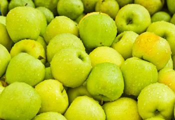 Many ripe apples on open air market