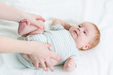 mother doing gymnastics her baby infant