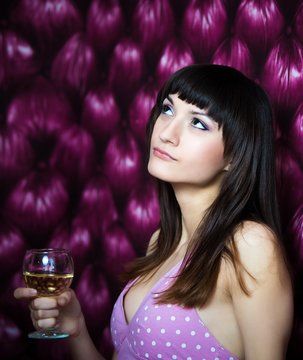 Pensive woman holding a glass of wine