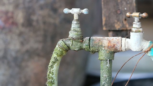 Water drop,leaking from old valve tap.