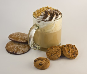 Cafe latte with walnuts, hazelnuts and biscuits