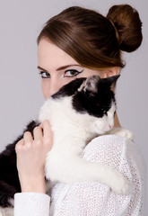 Elegant lady holding black and white cat