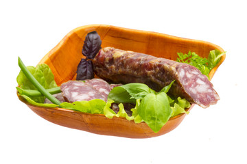 Ripe salami with salad, basil, onion and tomato