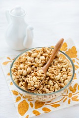 Bowl of puffed wheat cereal for breakfast