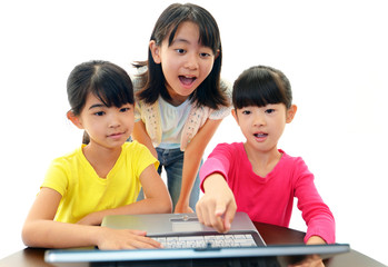 パソコンを楽しむ３人の女の子