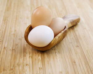 Whole Organic Eggs in Wooden Spoon