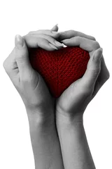 Fotobehang Rood, wit, zwart Rood hart in tot een kom gevormde handen.