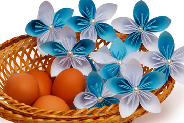 Paper flower with eggs in a basket