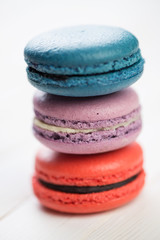 Fototapeta na wymiar Stack of differently colored macaroons, close-up