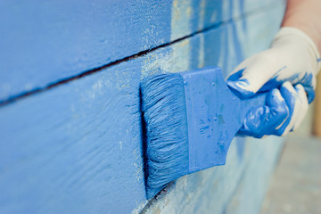 hand painting blue wooden wall 