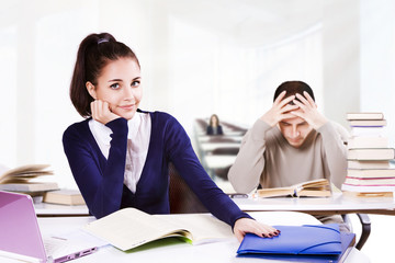 Students working at desks in library