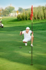 Golfer lining up a putt.