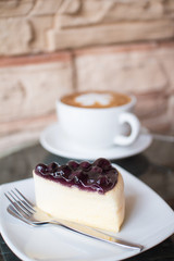 Hot coffee  and blueberry cheesecake.